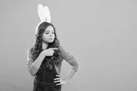 Promoting goods. Small girl wear bunny ears. Kid in rabbit costume. Spring holidays. Easter funny bunny. Happy easter. Seasonal sale and discount. Shopping and retail. Preparing for Easter holidayの写真素材