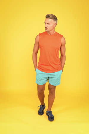 I will not be stopped. Sportsman yellow background. Strong sportsman in gym clothes. Sportsman physically fit. Active sportsman. Health and healthy lifestyle. Sport and fitness. Training and workoutの写真素材