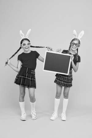 family preparing for Easter. kids having fun. Sisters celebrate holiday. best easter egg hunt. children at egg hunt in bunny. happy easter. funny girls with Easter eggs. copy spaceの写真素材