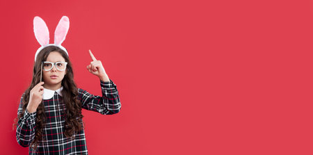 child in party glasses. time for fun. adorable kid wearing funny hare ears. easter spring holiday.の写真素材