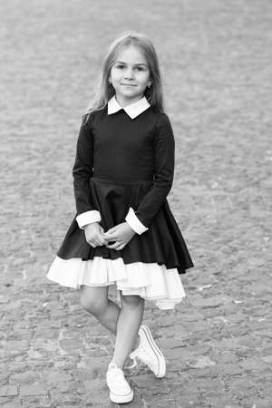 Elegance that you deserve. Little child wear uniform dress outdoors. Back to school fashion. Fashion look of small girl. School dress code. September 1. Formal education. Fashion trends for fallの写真素材