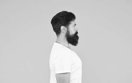 Bushy beard hipster man barbershop client yellow background, perfect side view conceptの写真素材