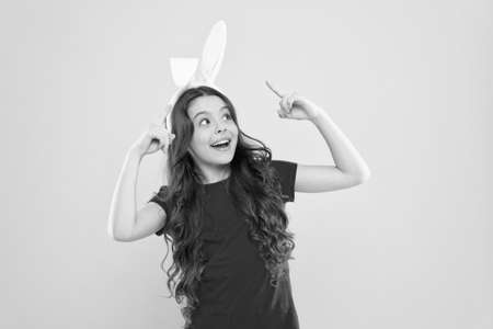 Good mood. Bunny Girl child wear rabbit ears. Join my party. Spring season. Holiday celebration. Charismatic baby advertising easter topic. Little child celebrate Easter. Small child Easter styleの写真素材