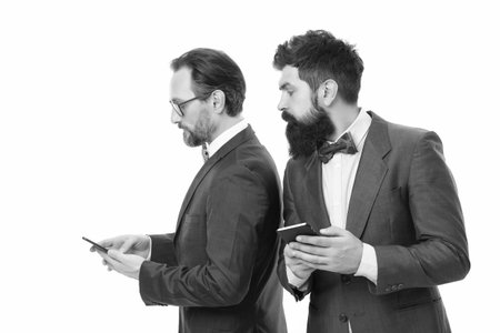 secret business. business communication on meeting. team success. collaboration and teamwork. partnership of men speaking on phone. mature men. Agile business. bearded businessmen in formal suitの写真素材