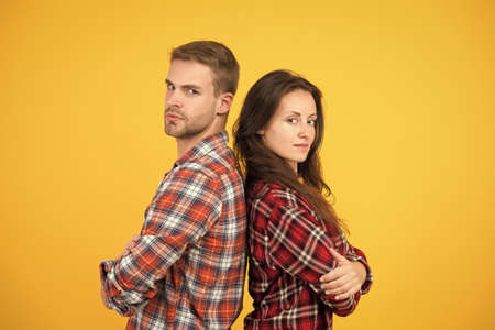 Adult siblings. Sister and brother. Confident team. Back to back standing man and woman. Fashion...