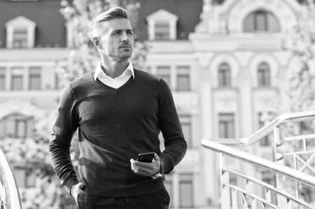 Confidence is everything. Confident man with phone on urban outdoor. Confident look of modern guy. Casual fashion and style. Menswear shop. Mens wardrobe. Confident and stylish. Look more confidentの写真素材