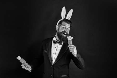 Feel the song. Easter singer. Businessman pretend singing with carrot. Bearded man sing song black...
