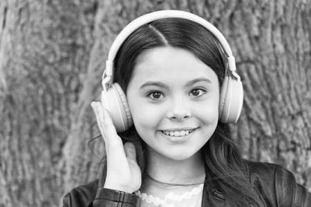 Hipster girl listening music modern headphones nature background, skip track conceptの写真素材