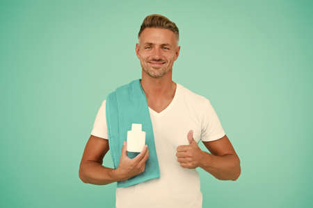 After shaving care. Cosmetics for men. Beauty product. Handsome well groomed healthy guy recommend...