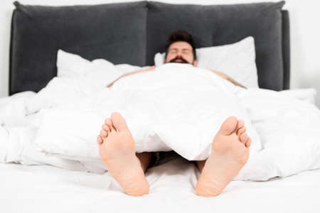 male pedicure. What a great morning. sleepy man in bedroom. man sleep in morning. energy. asleep and...