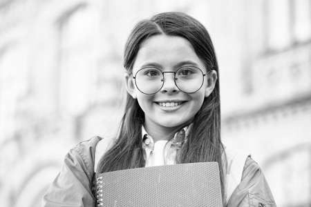 Feeling happy about doing homework. Happy child back to school. Little kid hold books. Homework assignment. Afterschool activities. Home schooling. School and education. Homework routineの写真素材