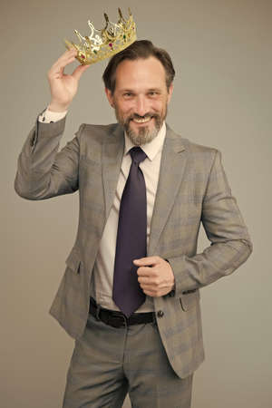 High on confidence. Big boss grey background. Happy man wear luxury crown. Bearded man in...