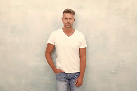 Fashion model in casual style clothes. Man wearing white tshirt. shirt makes man look more trendy. successful macho man. being sexy this season. Elegance stays in fashionの写真素材