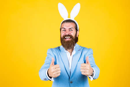 Getting ready for this. celebrating easter in springtime. funny man in rabbit costume. happy easter. man imagine he is rabbit. male wear bunny ears. just having fun. Easter Holiday Greetingの写真素材