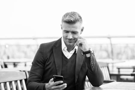 Internet connection. Useful application. Business communication. Send message. Mobile lifestyle. Online communication. Modern communication. Businessman hold mobile phone. Handsome man with phoneの写真素材