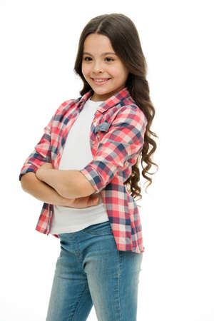 Kid girl long curly hair posing confidently. Girl curly hairstyle smiling face feels confident. Child hold hands confidently crossed chest. Upbringing confidence. Feel so confident with new hairstyleの写真素材
