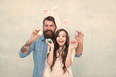 Happy to be a family. Daughter and father hunting eggs for Easter holiday. Having fun on Easter....