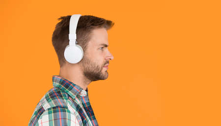 Recording sample. Stereo sound. Hipster listen music. Music taste. Man in earphones. Mp3 player. Education audio book. Modern technology. Handsome radio host. Music chart. Creating sound and songsの写真素材