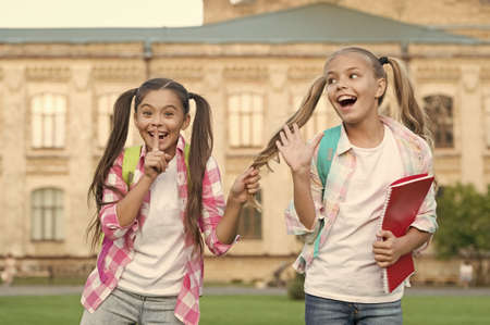Happiness and joy. Smiling friends having fun at school yard. Happy schoolmates. School camp. Modern education. Teens with backpacks. Girls school background. STEM summer camps and courses for kidsの写真素材