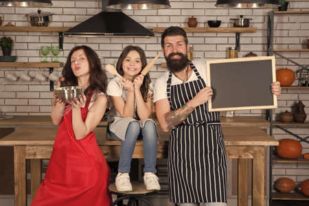Baking cookies. Culinary school. Mother father and daughter cooking together. Child with parents cooking in kitchen. Family preparation holiday food. Our week menu. Baking food. Baking cakeの写真素材
