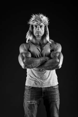 Confident man cross strong muscular arms with biceps triceps muscles in casual wear black background, confidenceの写真素材