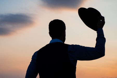 Real freedom. agile business. loneliness. need the inspiration. man feel motivation. businessman in hat silhouette on sky background. confidence and success. concept of successful futureの写真素材