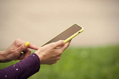 Providing mobile technology to users. Smartphone with touchscreen technology. Cellphone in female...