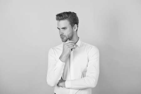 confident unshaven man in white shirt has groomed hair, male hairdresserの写真素材
