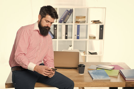 Mobile solution for business. Businessman text sms. Bearded man work in business office. Trading business. Business communication. New technology. E-commerce.の写真素材