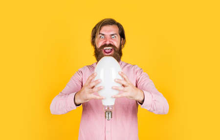 brutal bearded male man hold lamp bulb, electricityの写真素材