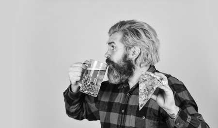 Perfect rest in pub. Finally pizza time. Pizza is better when shared. Pizzeria restaurant. Gourmet food. Cheerful man bearded hipster hold pizza. Hungry man going to eat pizza and drink beerの写真素材