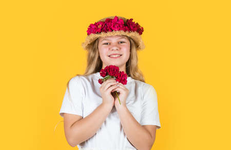 happy teen girl in straw hat with rose flowers, summerの写真素材