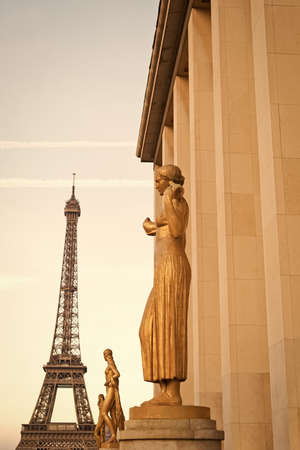 Paris, France - September 29, 2017: golden statues with Eiffel tower on background. Architecture and art. Architectural structure and construction. Tourist landmark. Traveling and discoveryのeditorial素材