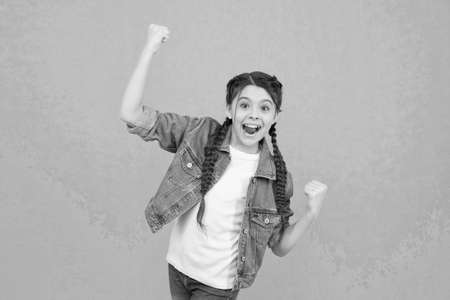 Act like winner today. Happy winner celebrate win green background. Little child make winning gesture. Celebrating victory or success. Beauty look. Casual fashion. Trendy style. Your are lucky winnerの写真素材