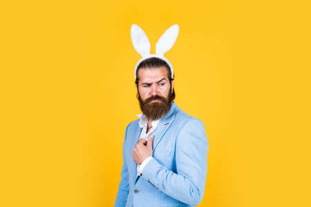 mature bearded male guy looking elegant wearing bunny ears, easterの写真素材