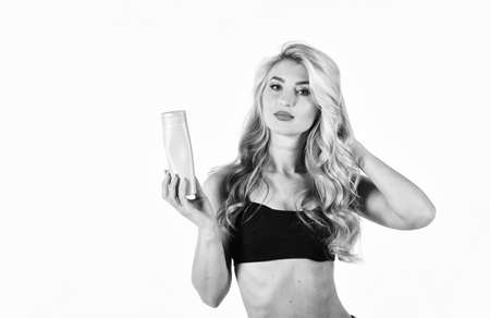 Concept spa salon. The concept of hair care. Oil hair treatment for woman. bottle with hair oil. Young blonde woman with curly hair. haircare concept. The beauty face. choosing a new hairstyleの写真素材