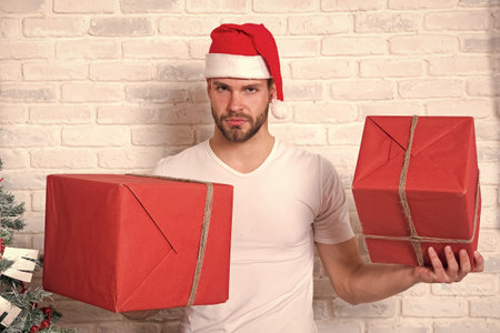 Man santa with boxes on white brick wallの写真素材