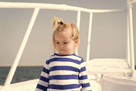 Sea is his vocation. Baby boy enjoy vacation cruise ship. Child cute sailor yacht sunny day. Boy adorable sailor striped shirt white yacht travel around world. Adventure of boy sailor travelling seaの写真素材