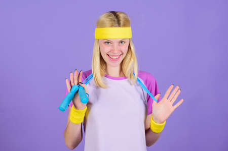 Proper approach to lose weight. Weight loss concept. Jumping rope is great calorie burner. Girl hold jumping rope wear bright wristbands. Woman exercising with jumping rope. Jumping exercise benefitsの写真素材
