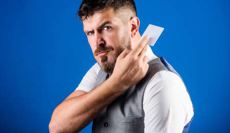 Plastic bank card. Easy money credit. Which bank credit card easy to get. Man bearded hipster hold plastic blank card blue background. Take this card. Make shopping easy. Banking and credit conceptの写真素材