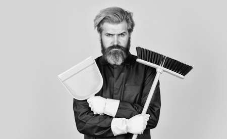 Garbage removal. Cleaning day. Janitor professional. Bearded hipster blue uniform with broom....