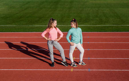 girls kids relax after training sport outside on stadium arena, childhoodの写真素材