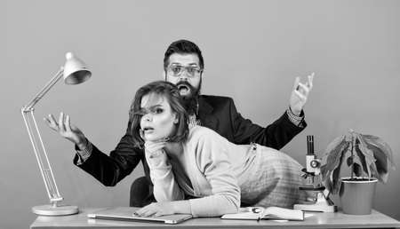 Private lesson. Flirting with teacher. Student sensual sexy girl and experienced teacher. Resist temptation. She keeps me from working. Mature teacher and attractive female. Banned relations conceptの写真素材