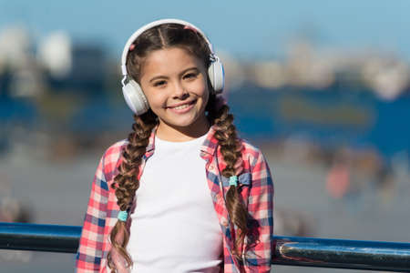 Music for the pure pleasure. Small child using technology for leisure or music education. Small kid...