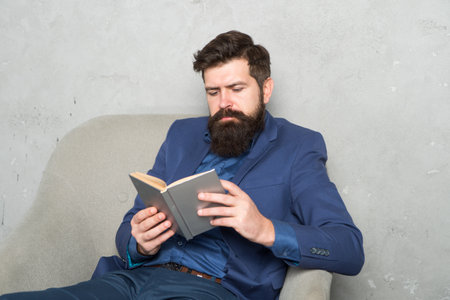 Reading authority business book. Business experience. Decision making part management. Man bearded businessman thoughtful face inspired by book making decision. Business decision. Useful informationの写真素材