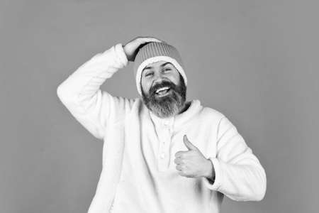 Fashion concept. Winter clothes and accessories. Feeling good. Mature emotional hipster funny style accessory. Bearded hipster. Hipster style. Head in warm hat. Handsome man knitted hat with pom pomの写真素材