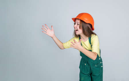building and construction. child architect worker. engineer on grey background.
