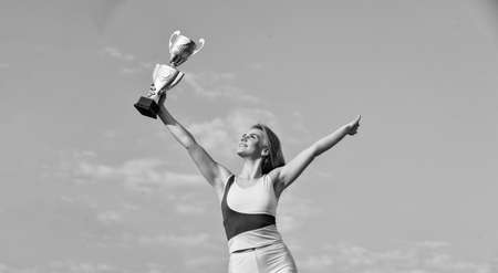 Well deserved reward. Achievement. Successful athlete. Athletic woman leader. Sport motivation. Sport success. Winner girl. Sport and health. Competition concept. Happy champion. Best player titleの写真素材