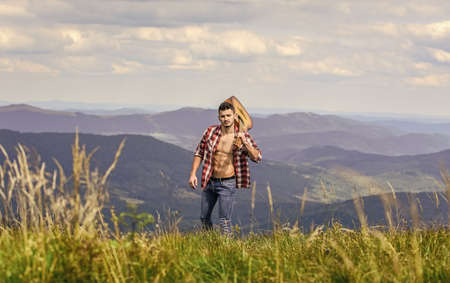 Entertainment. sexy man with guitar in checkered shirt. hipster fashion. western camping and hiking. happy and free. cowboy man with bare muscular torso. acoustic guitar player. country music songの写真素材