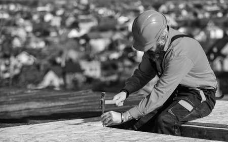 Roofer working. Roofer working tool. Construction Industry and Waterproofing. roofer working on roof...